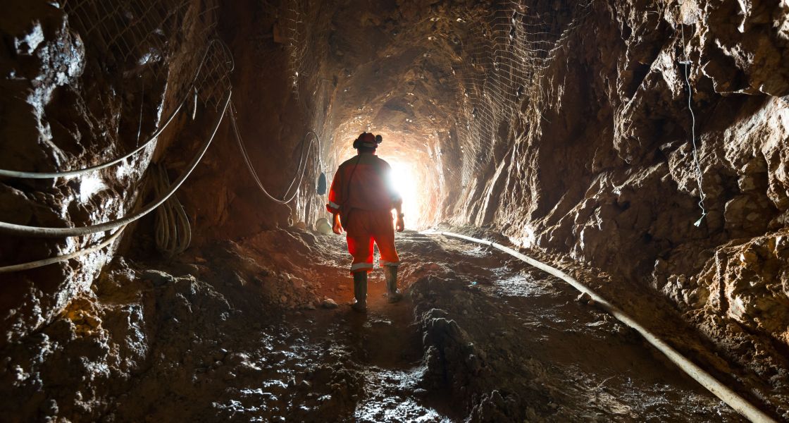 Bergbauarbeiter im Minenschacht im Gegenlicht fotografiert